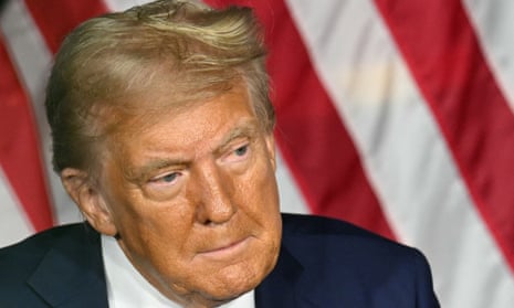 a man in closeup before a US flag