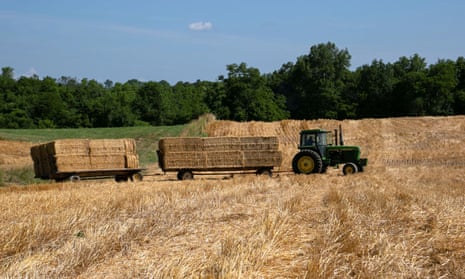A tractor transports bales of straw after a harvest in Shelbyville, Kentucky.