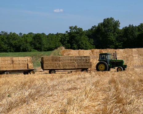 A tractor transports bales of straw after a harvest in Shelbyville, Kentucky.