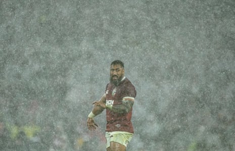 A footballer stands in the middle of the football ground at Homebush for the rugby test between Australia and the UK, drenched in rain