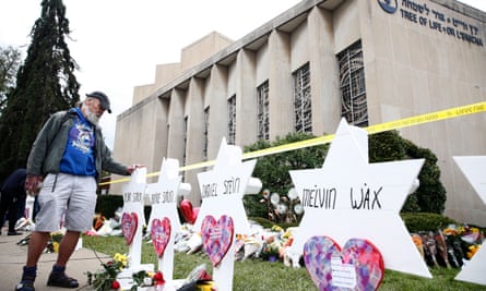 A man pauses at the memorials set up for each of the 11 people killed at the mass shooting at the Tree of Life synagogue in Pittsburgh, Pennsylvania.