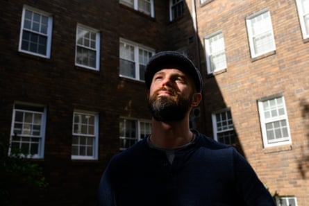 Hamilton posing outside near a block of flats