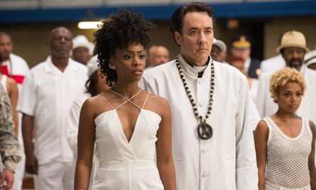 Hoarse with passion … John Cusack as Fr Mike Corridan with Teyonah Parris.