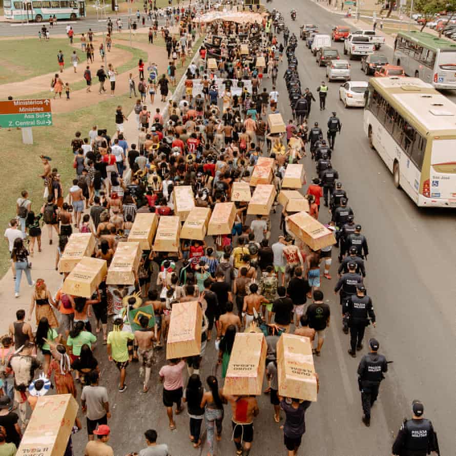 Indigenous people march in a procession called ‘Ouro de Sangue’ (Gold of Blood) to protest against Bolsonaro’s policies.