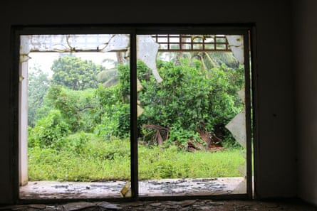 A broken window in the abandoned Sheraton hotel in the Cook Islands