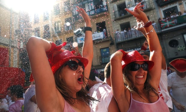 Women celebrate the firing of chupinazo, which opens the San Fermín festival in Pamplona
