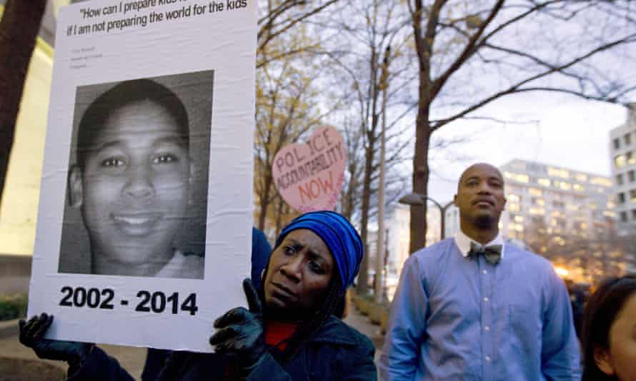 Tomiko Shine holds up a poster of Tamir Rice at a protest in Washington on December 1, 2014.