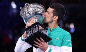 Novak Djokovic celebrates with the Australian Open trophy after beating Daniil Medvedev