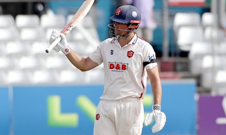 Alastair Cook raises his bat in acknowledgement