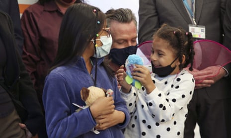 Governor Gavin Newsom takes a photo with Luna Peña, five, right, and another child, both of whom had received their Covid-19 vaccines at a clinic in San Francisco on Monday.