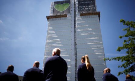 Firefighters in front of the abandoned tower block.