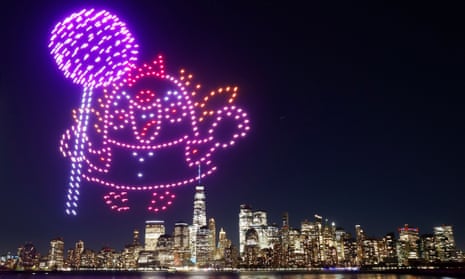 A character holding a lollipop is created by 500 drones over the skyline of lower Manhattan during an advertising promotion for the 10th anniversary of the video game Candy Crush Saga in New York City on November 3, 2022