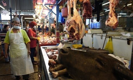 A poultry butcher at a wet market in Kuala Lumpur.
