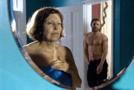 film still of Anne Reid looking in the mirror at a topless Daniel Craig behind her