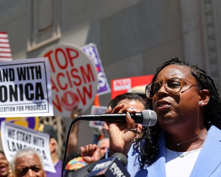 Woman in crowd speaks into microphone