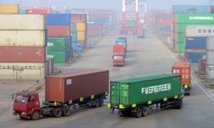 Trucks drive through a container depot at at Qingdao in eastern China’s Shandong province. China is heading for its weakest growth for 25 years.