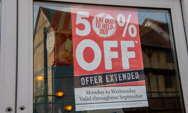 An EAt Out to Help Out offer extended sign in a restaurant window