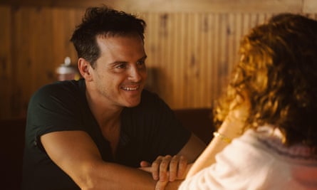 man smiling at a woman in a wood pannelled room in a film still