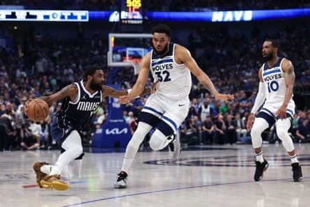 Karl-Anthony Towns of the Timberwolves defends Kyrie Irving of the Mavericks during the Western Conference finals.