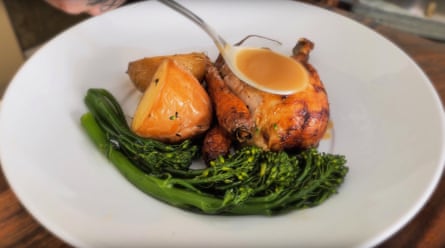 Close-up of a plate of roast chicken with broccolini, roast potatoes and carrot.