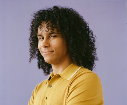 Clay Lute wearing a mustard top against a lilac background