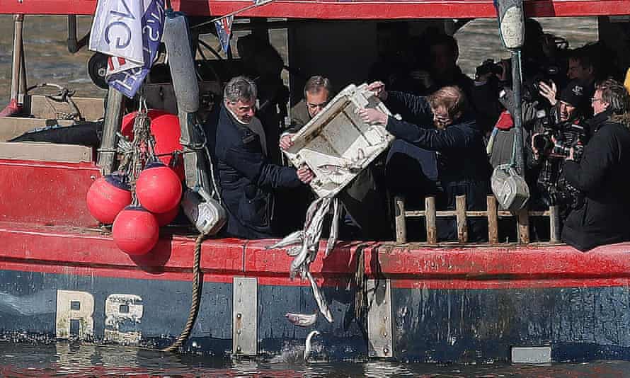 Nigel Farage throws fish into the Thames to protest against common fisheries policy.