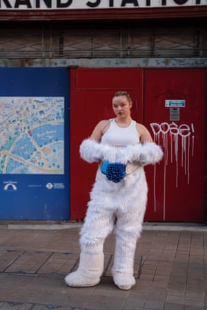 Fashion designer Emma van Engelen wearing white fluffy gloves and trousers, Yeti moon boots and a 3D printed bag at London Fashion Week