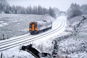 A train runs along the tracks in snowy North Yorkshire