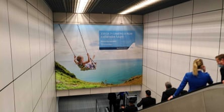 The banner at Schiphol Airport showing a child on a swing