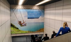 Billboard ad featuring image of a child on a swing and blue ocean and sky, and bearing slogan 'join us in creating a more sustainable future'