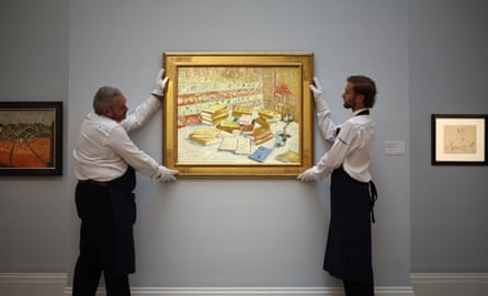 Gallery assistants position Romans Parisiens by Vincent van Gogh at the art fair.