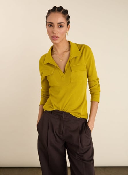 woman wearing chartreuse top with hands in pockets