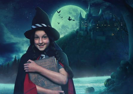 Bella Ramsey dressed as a witch holding a book of spells to her chest, standing against a spooky background of a castle, a large moon and some bats