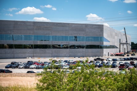Cars sit parked outside Tesla’s Gigafactory on the east side of Austin.