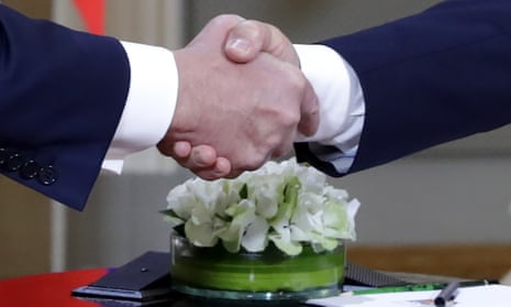 US President Donald Trump (left) and Russia’s President Vladimir Putin shake hands during a meeting at the Presidential Palace