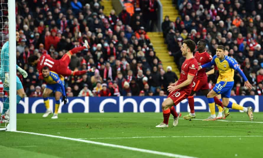 Diogo Jota scores Liverpool’s second goal from a cross by Mohamed Salah, who is being sent flying in the background