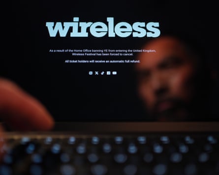 A person looks at a laptop showing the homepage of Wireless festival announcing that the festival has been cancelled