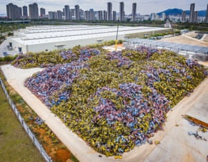 A crane unloads shared bikes from trucks in Xiamen