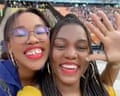 two women smiling to camera in a selfie in a stadium