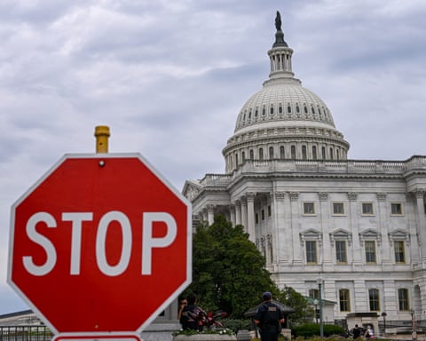 A stop sign is seen in front of the US Capitol dome in Washington DC on 30 September