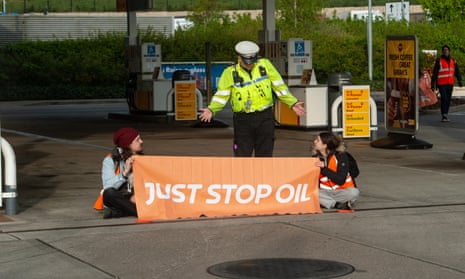 Police arrive on the scene as activists from Just Stop Oil target a Shell petrol station in Cobham