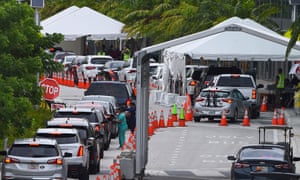 In this file photo taken 22 July, cars line up for Covid-19 test at a “walk-in” and “drive-through” coronavirus testing site in Miami Beach, Florida. Two key weapons in the state’s fight are misfiring badly: testing and contact tracing.