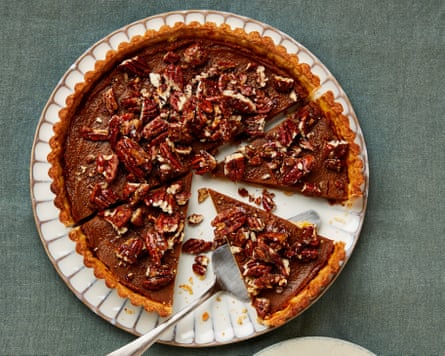 Pumpkin pie on a place with a slice cut out
