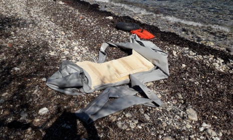 The remains of a newly landed inflatable dinghy on a beach on Lesbos