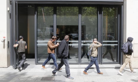 Four police officers leave the building hosting the McKinsey offices in Paris in May this year.
