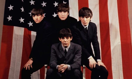 The Beatles in front of a US flag