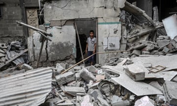 A Palestinian child inspects the damage after an Israeli strike on a house in Rafah, Gaza.