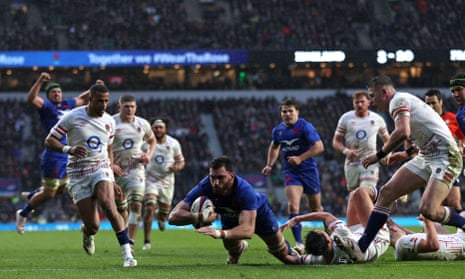 France’s flanker Charles Ollivon (centre) dives over the line to score.