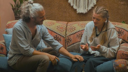 A man with his hand on a woman’s knee.