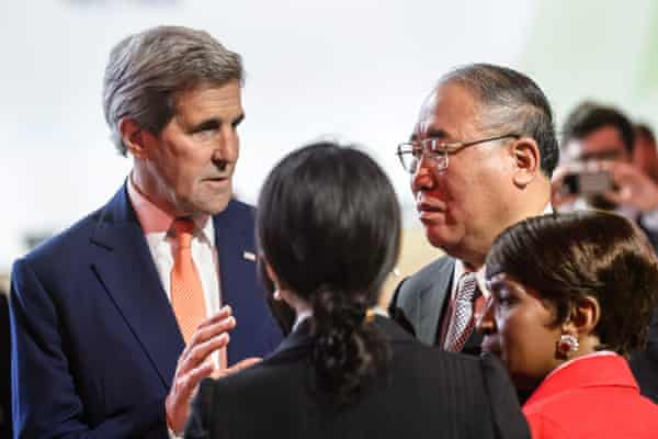 Then US state secretary John Kerry, left, talking with Xie Zhenhua, right, representing China, before the plenary session where the final agreement of Cop21 was presented in Paris in 2015